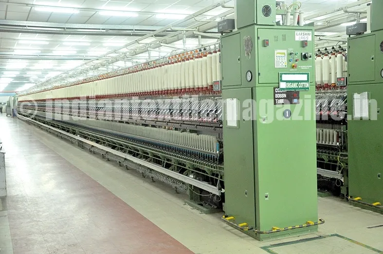 Interior view of Rajapalayam Mills showing rows of textile spinning machines in operation.